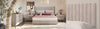 Neatly arranged bedroom with a bed, nightstands, and decorative items.
